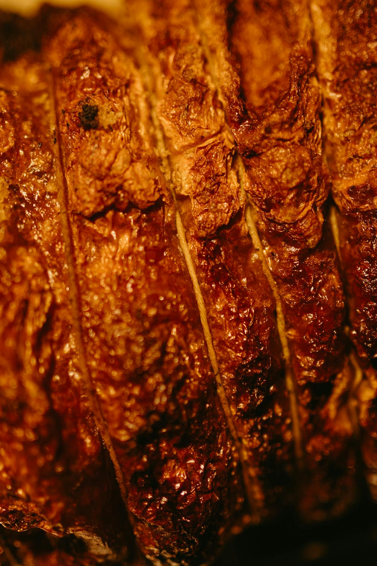 Close-up of a smoked meat surface with a dark, crackly crust, the kind of set bark you want on a properly cooked brisket